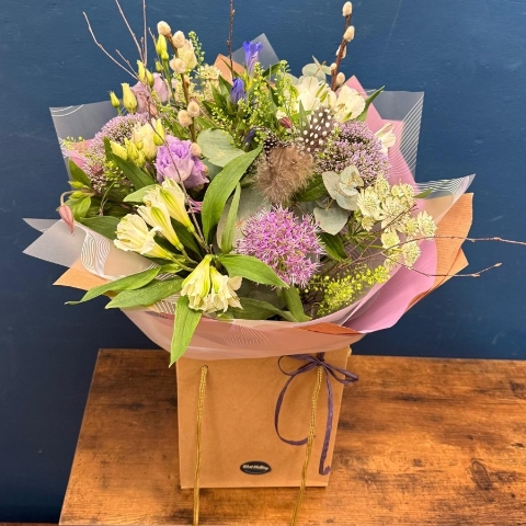 Pastel spring hand tied bouquet with pink white and lilac seasonal flowers
