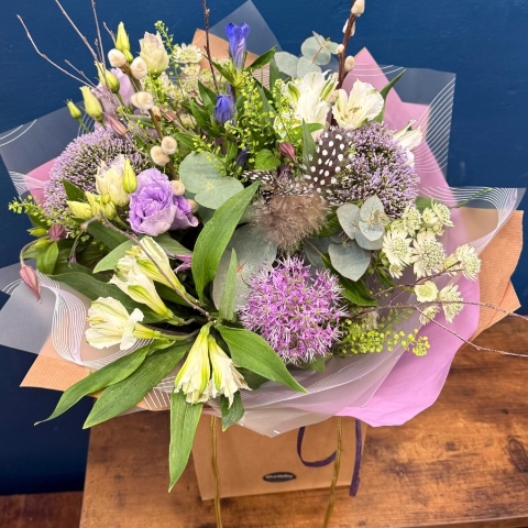 Pastel spring hand tied bouquet with pink white and lilac seasonal flowers
