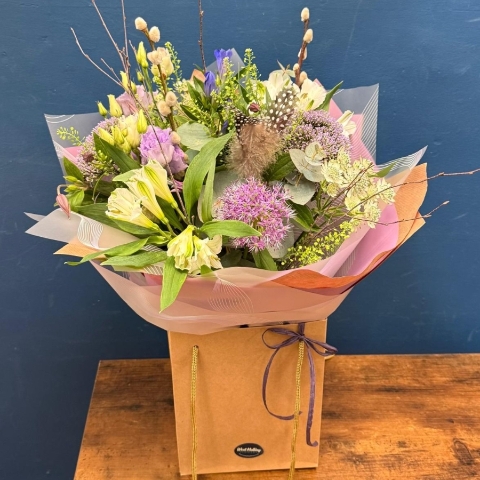 Pastel spring hand tied bouquet with pink white and lilac seasonal flowers