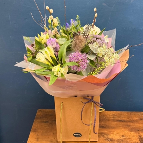 Pastel spring hand tied bouquet with pink white and lilac seasonal flowers