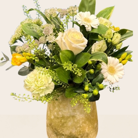 Yellow and white summer flower arrangement in decorative lemon vase