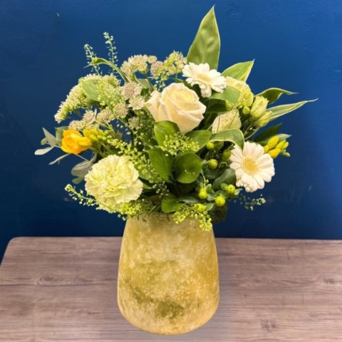 Yellow and white summer flower arrangement in decorative lemon vase