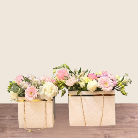 Mother’s Day flower arrangement in a white handbag gift container with soft pastel blooms, Paris collection West Malling florist