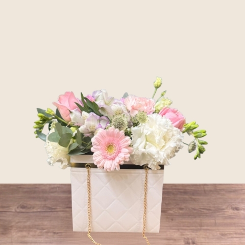 Mother’s Day flower arrangement in a white handbag gift container with soft pastel blooms, Paris collection West Malling florist