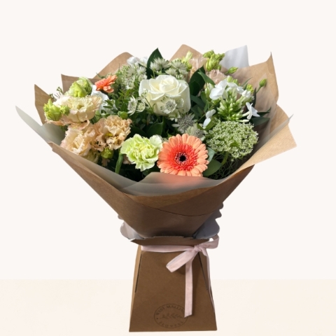 Late summer hand-tied bouquet with peach, cream and white seasonal flowers, fresh greenery and gift box.