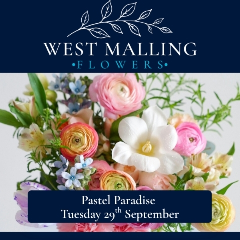 Soft pastel floral arrangement in a glass vase created during a West Malling Flowers floristry workshop using seasonal flowers and textured foliage.