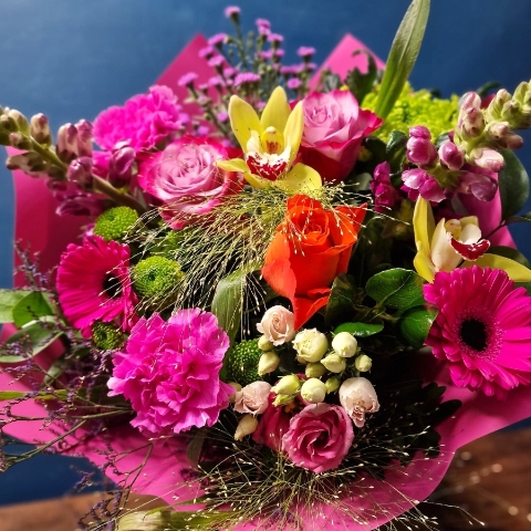 Bright summer hand tied bouquet with cerise purple orange and lime seasonal flowers
