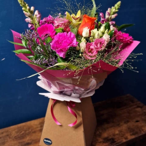 Bright summer hand tied bouquet with cerise purple orange and lime seasonal flowers