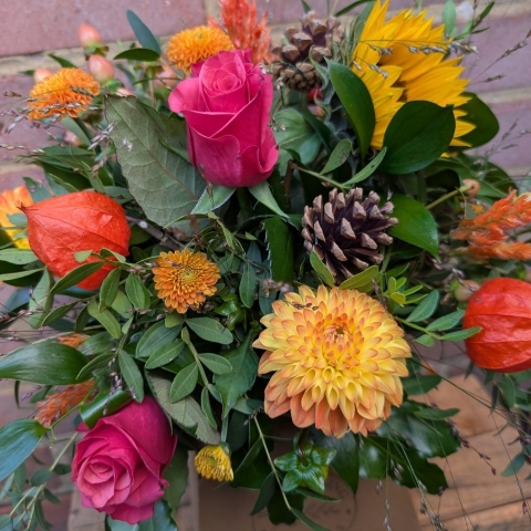 Autumn Glow box arrangement with orange, raspberry, bronze, yellow and burgundy seasonal flowers