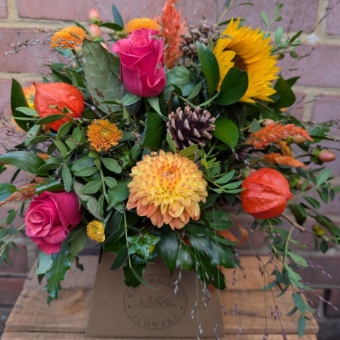 Autumn Glow box arrangement with orange, raspberry, bronze, yellow and burgundy seasonal flowers