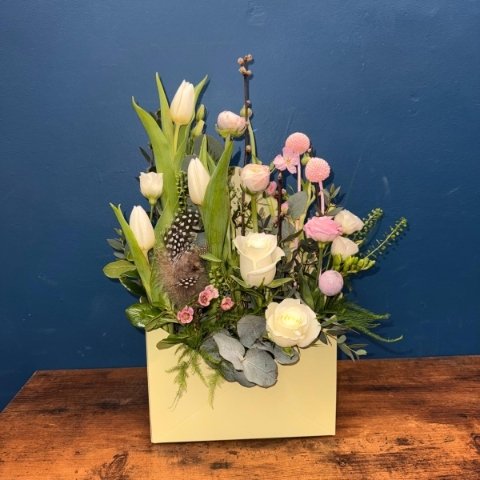 Spring envelope flower arrangement with pink and white seasonal flowers