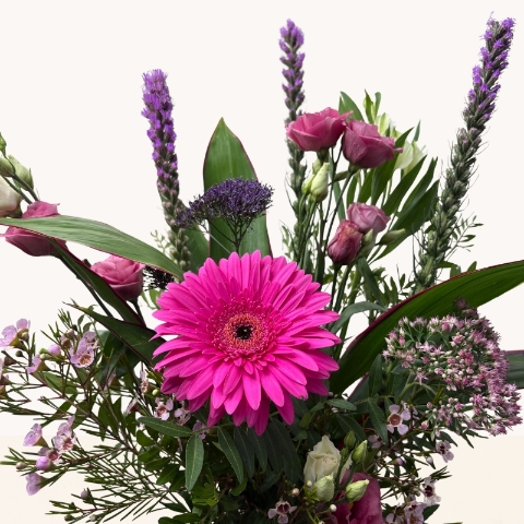 Summer Splash glass vase arrangement with vibrant pink and purple seasonal flowers by West Malling Flowers