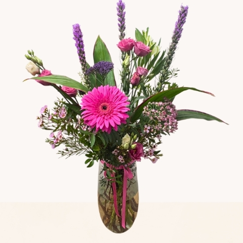Summer Splash glass vase arrangement with vibrant pink and purple seasonal flowers by West Malling Flowers