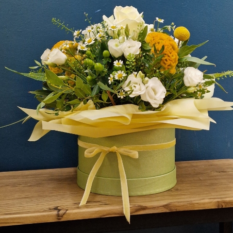 Citrus summer hat box arrangement with yellow and white seasonal flowers and unique wrapped design