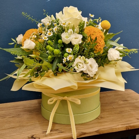 Citrus summer hat box arrangement with yellow and white seasonal flowers and unique wrapped design