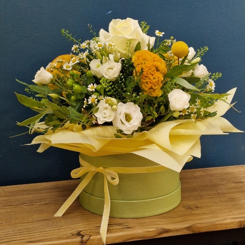Citrus summer hat box arrangement with yellow and white seasonal flowers and unique wrapped design