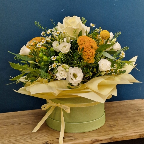 Citrus summer hat box arrangement with yellow and white seasonal flowers and unique wrapped design