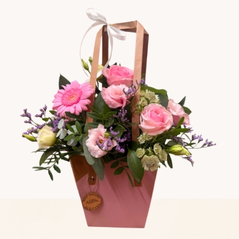 Summer Blush pink bag arrangement with pink roses, gerbera and soft pastel seasonal flowers