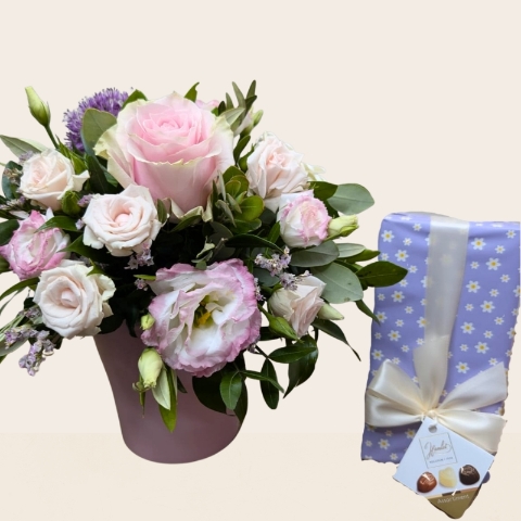 Summer flower arrangement in ceramic clay pot with pink heart design and pastel pink purple flowers