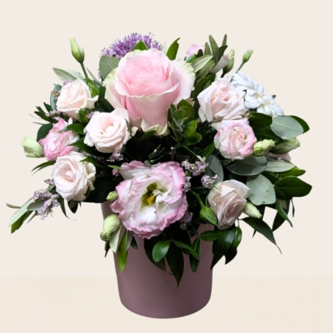 Summer flower arrangement in ceramic clay pot with pink heart design and pastel pink purple flowers