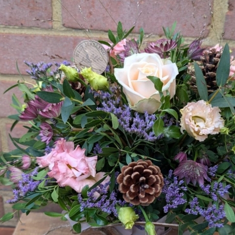 Autumn Blush flower arrangement in cork and cream cotton bag with pink, champagne and lilac flowers