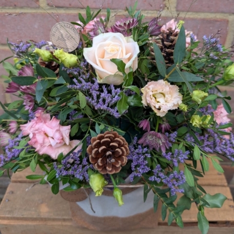 Autumn Blush flower arrangement in cork and cream cotton bag with pink, champagne and lilac flowers