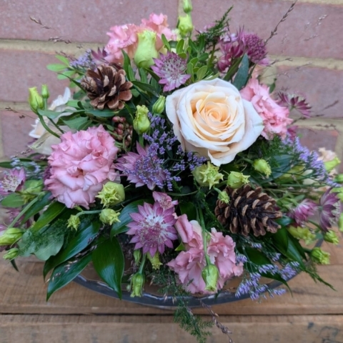 Autumn Blush flower arrangement on a glass cake plate with pink, champagne and lilac seasonal flowers