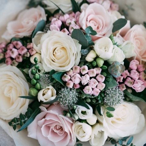 Romantic pastel bridal bouquet with blush pink and ivory seasonal flowers