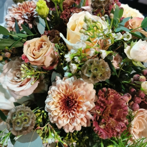 Modern bridal bouquet with deep red and burnt orange seasonal flowers