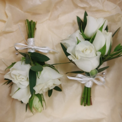 Pastel wedding buttonhole with seasonal flowers and natural foliage